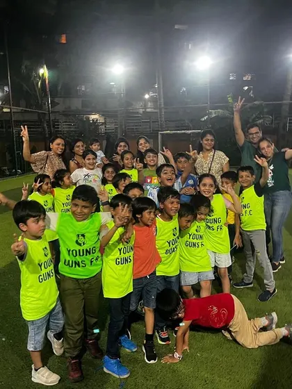 A massive group photo with kids and parents, all celebrating a fantastic multi-sport birthday party.