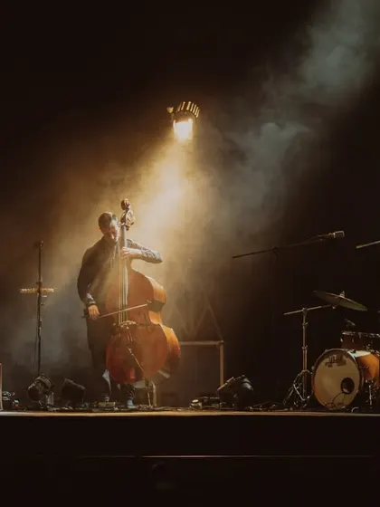 An atmospheric shot of Anoushka Shankar's band, with a single spotlight creating a warm, intimate mood.