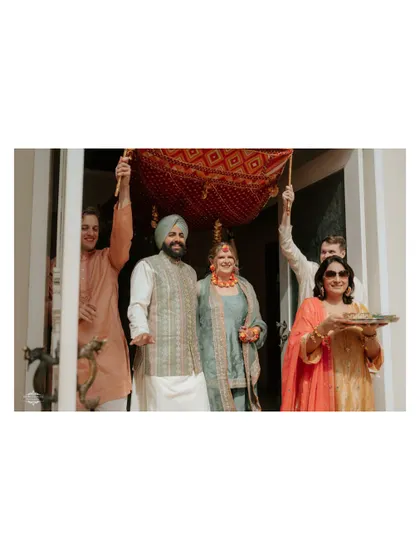 The couple makes their entrance at a traditional Punjabi ceremony. I focus on capturing the rituals and the family's involvement.