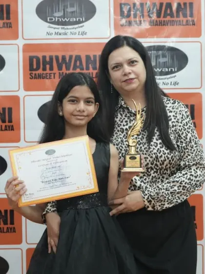 A mother and daughter celebrate receiving an award for their performance.