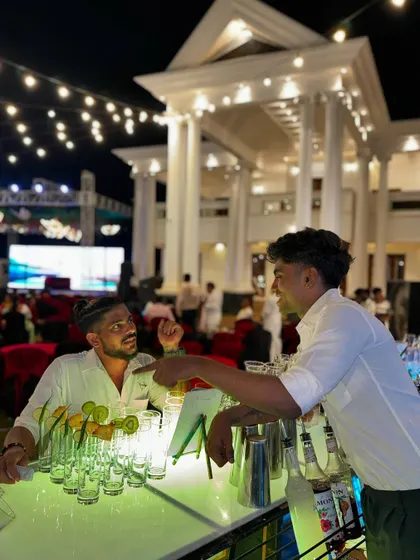 It's all about connection. One of our bartenders shares a friendly moment with a guest, showcasing the welcoming and engaging atmosphere we strive to create at every event.