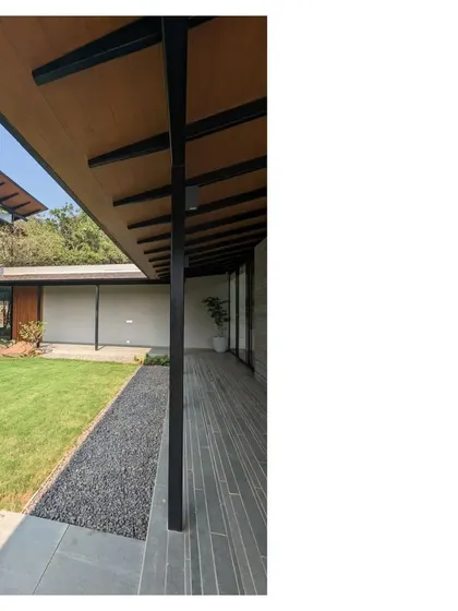 The long, covered verandah of Villa 15 in Alibaug. The one room thick plan frames a central courtyard, creating a home that breathes and provides a backdrop for joy, laughter, and memory making.