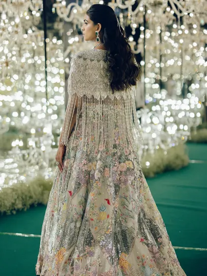 The back of Manisha's Rahul Mishra cape, showing the incredible craftsmanship and the dramatic, flowing silhouette. This is how you make an entrance.