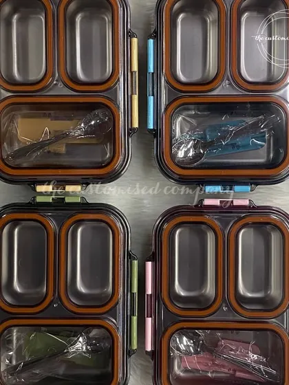A top-down view of our stainless steel, multi-compartment lunch boxes. The silicone seals ensure they are leak-proof, making them a practical and long-lasting choice for kids' meals.