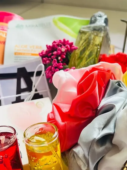 A closer look at the details in this bridesmaid gift basket. It combines practical skincare items with fun accessories like satin scrunchies and decorative candles, creating a balanced and thoughtful present.
