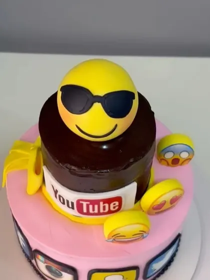 A close-up of the cool sunglasses emoji topper and YouTube logo.