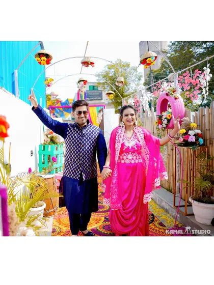 The couple's grand entrance to their Haldi ceremony, walking hand-in-hand through a decorated pathway.