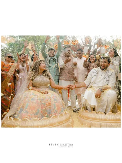 A celebration with family and friends. The air is filled with flowers and happiness in this joyous group shot from the Haldi ceremony.