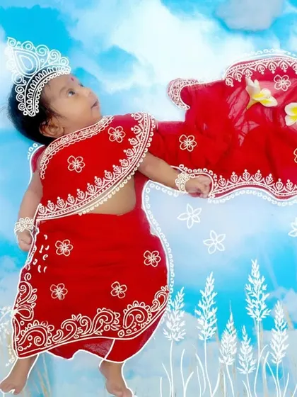 We love incorporating cultural traditions into our newborn sessions. This unique portrait celebrates Durga Puja, with the baby dressed as a little goddess, complete with festive doodles to mark the special occasion.