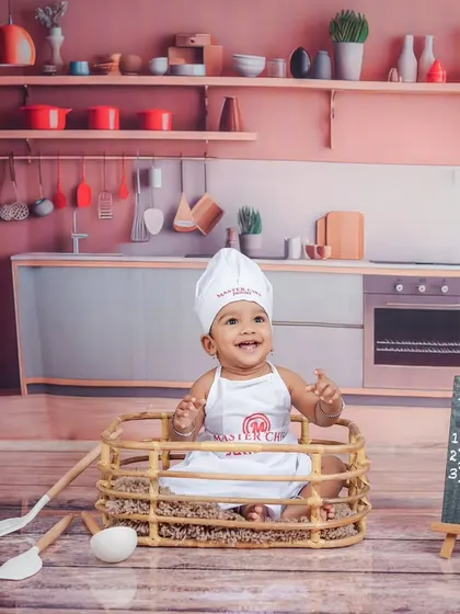 Let's get cooking! My studio has a variety of fun themes, like this 'Master Chef' setup, complete with a tiny chef's hat and a kitchen backdrop for your little foodie.