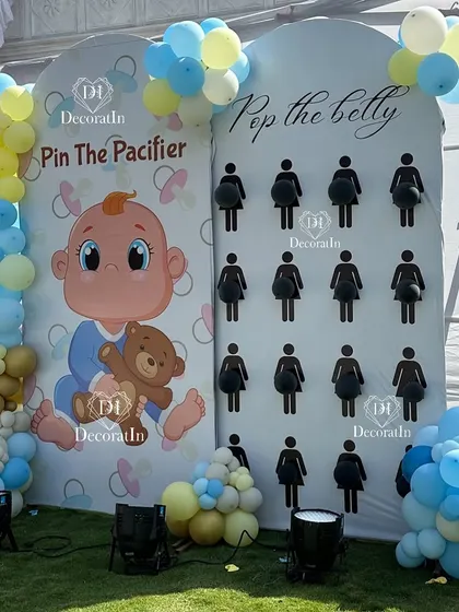 Game stations for the Krishna-themed shower, including "Pin the Pacifier" and "Pop the Belly."