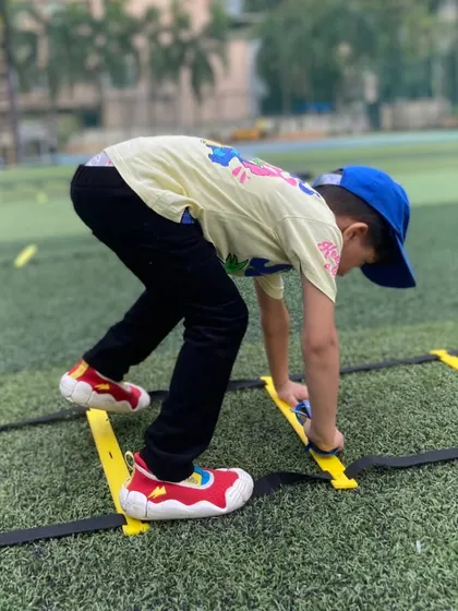 Quick feet in action. A young boy moves through an agility ladder during a birthday party, improving his coordination while racing against his friends in a fun and supportive environment.