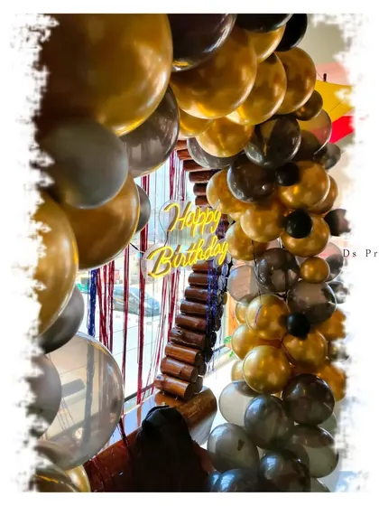 A detailed shot of the gold and black balloon arch.