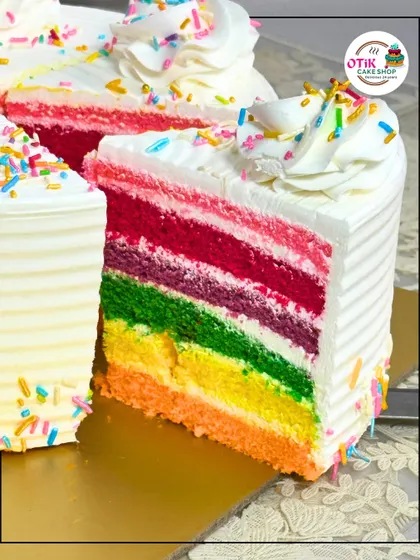 Taste the rainbow with this colorful and joyful cake. Each slice reveals vibrant layers of sponge cake, making it as fun to eat as it is to look at.