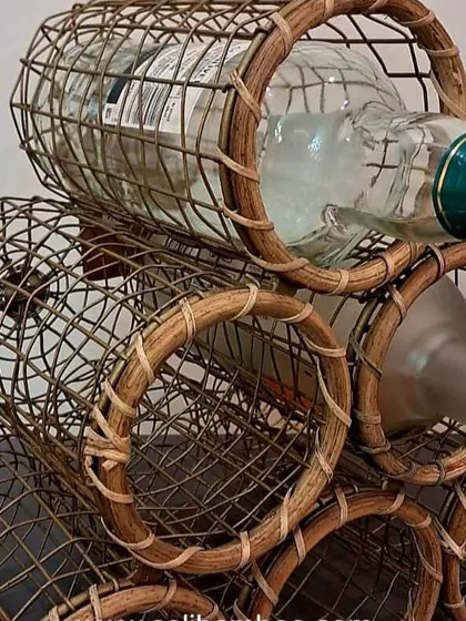 This portable, 6-bottle wine rack is handcrafted from cane and is perfect for picnics or as a stylish storage solution at home. Its sturdy design ensures bottles are held securely.