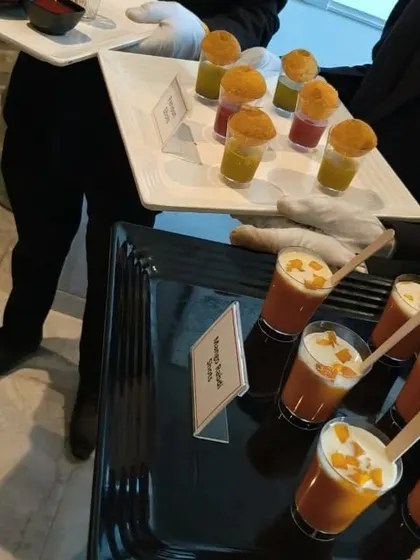 Our servers presenting a tray of Mango Rabdi Shots alongside our famous Pani Puri Shots. This shows how we can serve appetizers and desserts in a coordinated, easy-to-handle style.