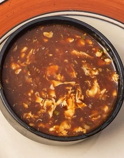 A classic Indo-Chinese favorite, our Manchow Soup is a spicy and savory dark broth filled with vegetables and topped with crispy fried noodles for a satisfying crunch.