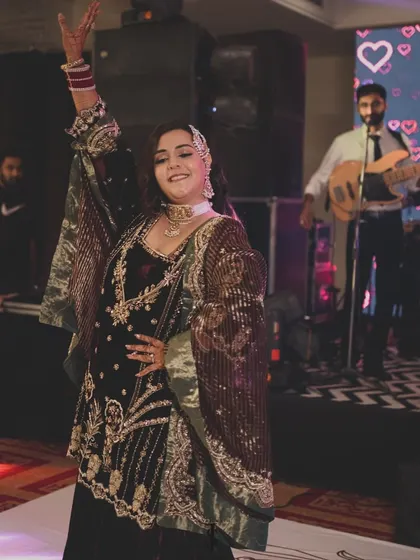 The bride enjoying the live band at her reception. Her elegant velvet outfit allows her to move and celebrate in style.