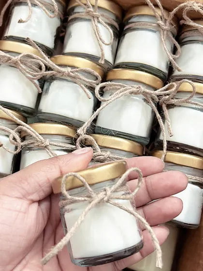 Mini jar candles tied with jute string. This rustic, boho style is very popular for weddings and outdoor events.