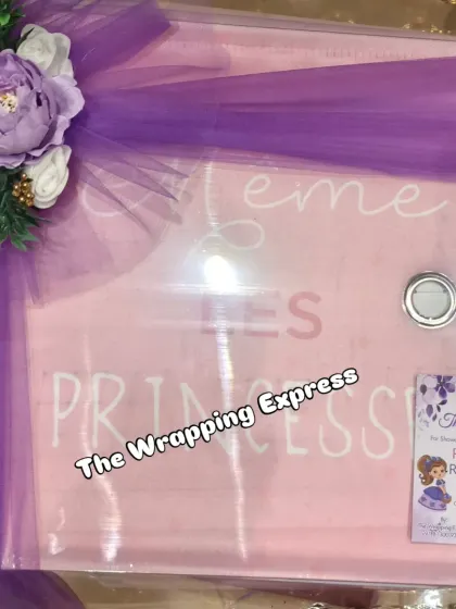 A personalized gift box with 'Little Princess' written on it, decorated with a purple bow.