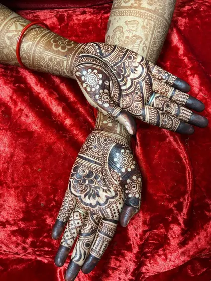 The stunning 24-hour stain of a full-coverage traditional design. The deep, dark color highlights the intricate paisley and floral patterns, covering the hands and wrists.