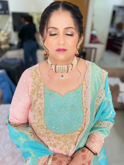 A close-up of the eye makeup, showing a soft, shimmery eyeshadow look that brightens the eyes. This is a perfect example of elegant makeup for mature skin.