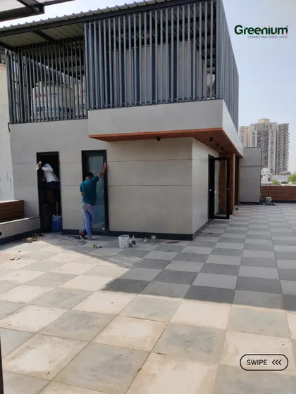 The "before" shot of a terrace area in Gurgaon. This image shows the bare tiled floor and mumty before my team transformed it into a stylish and green outdoor space.