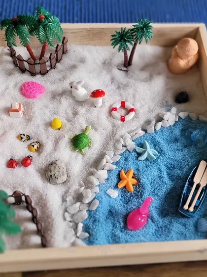 Here, a child has created a shoreline with white and blue sand, carefully placing tiny animals and a lifebuoy. Each garden tells a story and is a snapshot of the child's focus and imagination.