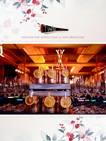 A stylish arrangement of copper mugs with dehydrated orange garnishes for a corporate anniversary event.