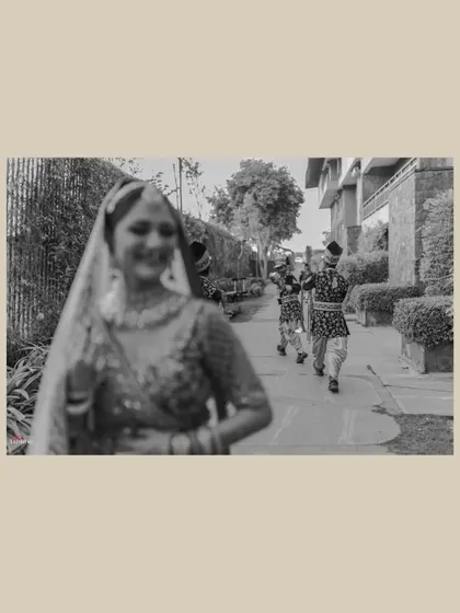 The moment the groom's procession arrives is full of anticipation. I used a creative focus technique here to capture the bride, Yashika, in the foreground, with the approaching baraat creating a sense of story and excitement.