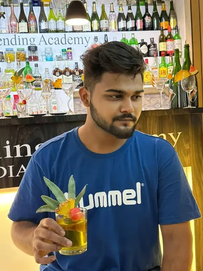 A tropical-style cocktail with a pineapple leaf garnish. We can create custom drinks to fit any theme, including tropical or beach parties.