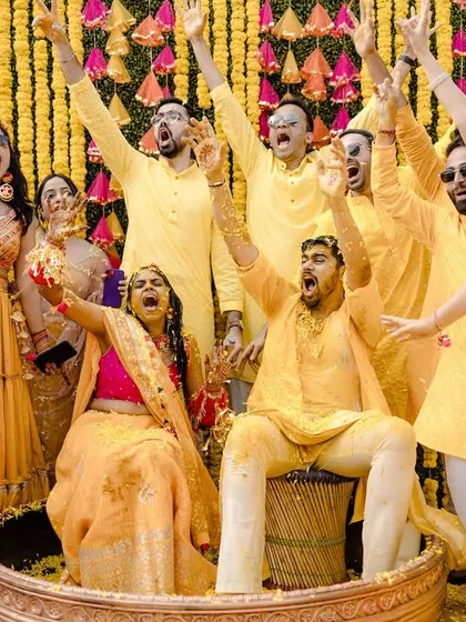 The whole squad gets in on the action. A fun group photo from the Haldi ceremony, with everyone cheering and celebrating.