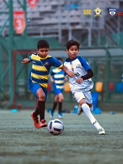 An intense duel for the ball between two young, determined players.