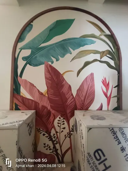 A colorful tropical leaf mural installed within a wooden arch frame.