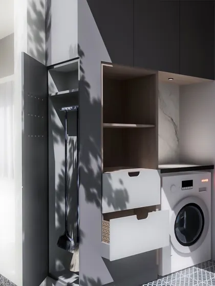 Even utility areas deserve good design. This compact laundry space features smart storage for cleaning supplies, a dedicated spot for the washing machine, and a clean, organized layout.
