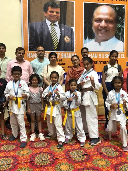 A group of my students and their families after a successful tournament. The support of parents is crucial, and we celebrate these achievements as a community.