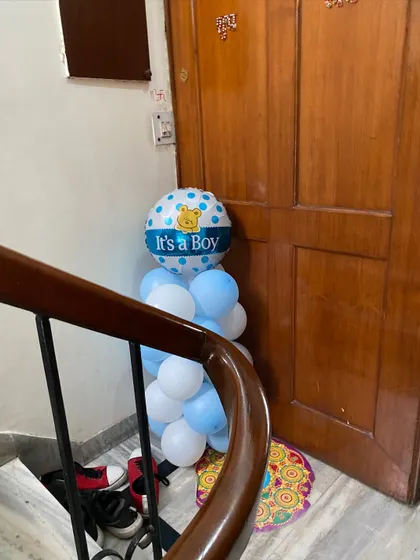 An 'It's a Boy!' balloon arrangement placed by a staircase, adding a festive touch to the entire home.