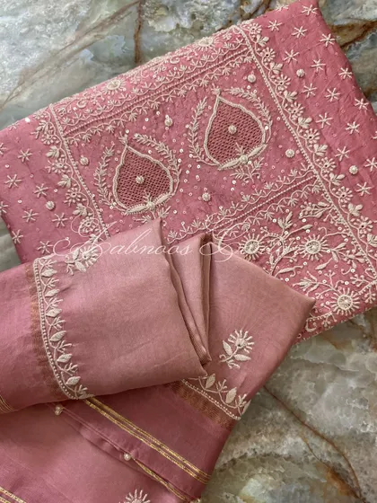 A folded view of the suit, perfect for appreciating the density of the embroidery.