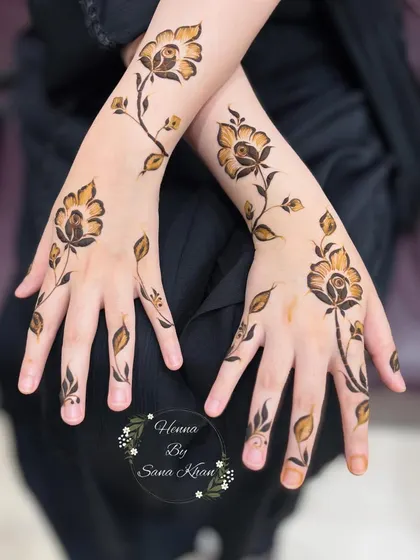 A pair of hands adorned with a beautiful rose vine design. This style is a favorite for bridesmaids and party guests.