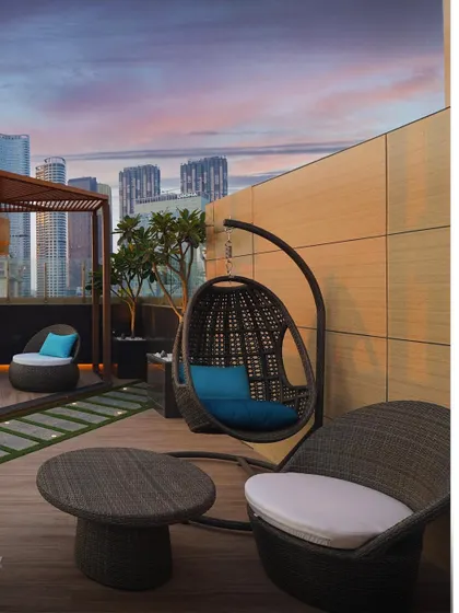 The rooftop terrace of our completed residential project in Lower Parel. We designed this space as an urban oasis, with a hanging swing chair and comfortable seating that offer a perfect spot to unwind against the backdrop of the city skyline.