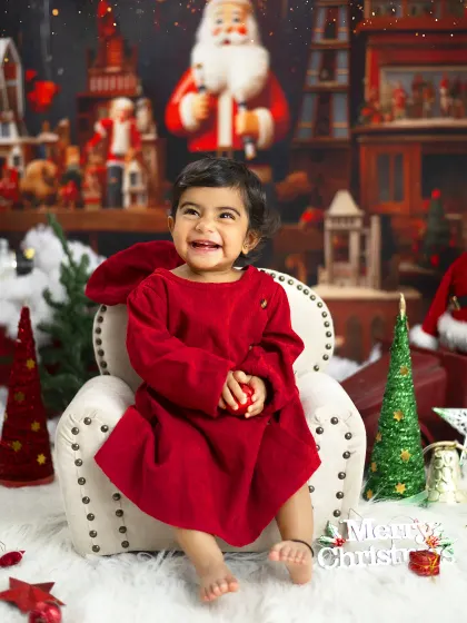 The pure joy of Christmas. This little girl's happy laugh is the centerpiece of this festive holiday portrait.