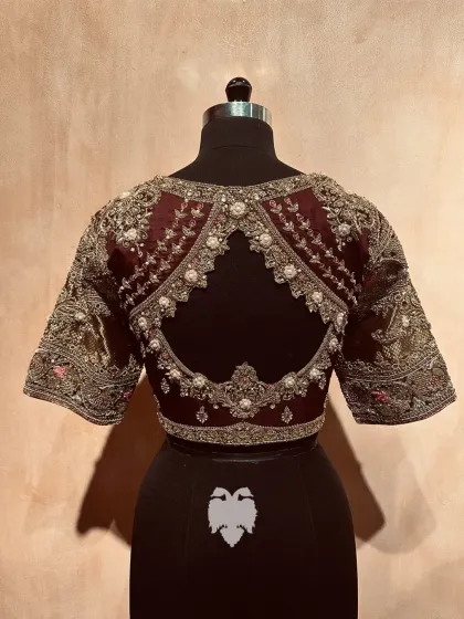 The beautiful cutout back of the brown silk blouse.