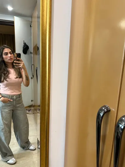 A casual look with a pink top and grey cargo pants.