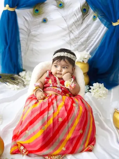 A thoughtful pose from this little darling. The details, like the peacock feathers and golden pots, make these festive shoots so special.