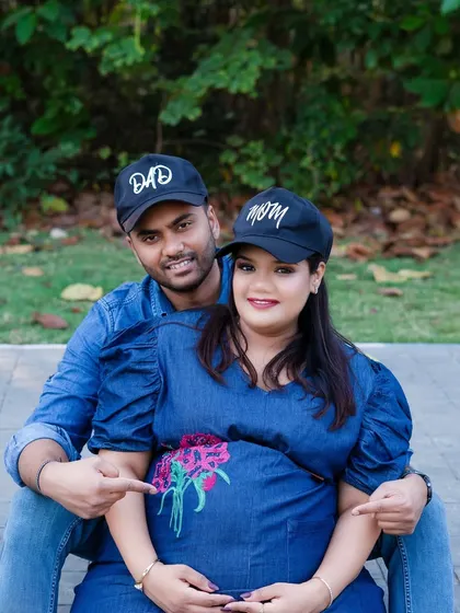 A fun and casual outdoor portrait of the parents-to-be. Using 'Mom' and 'Dad' caps adds a playful touch to this family memory.