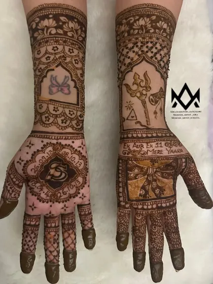 This customized mehendi features significant dates, a Ganesh motif, and other personal symbols that tell a unique story.