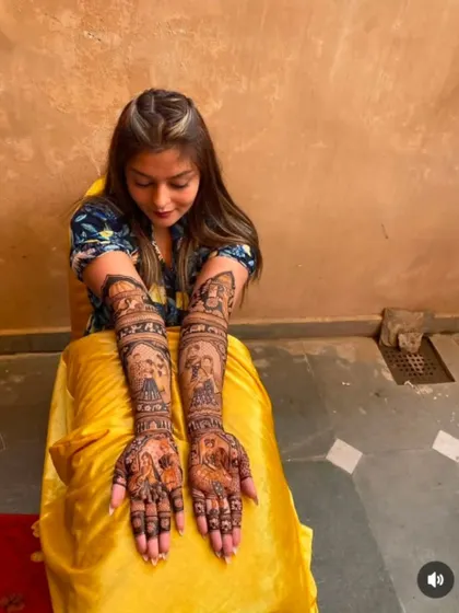 A full-length shot of a client with her beautiful, story-rich mehndi design.