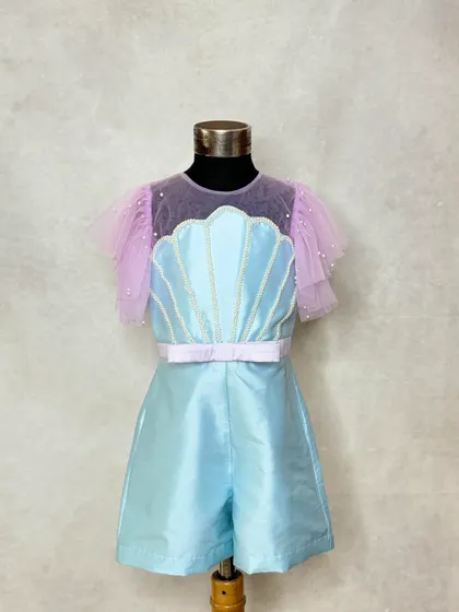 The playsuit portion of our mermaid-themed outfit. The shimmering blue fabric and seashell detail make it a complete look on its own, perfect for a play-area birthday party.