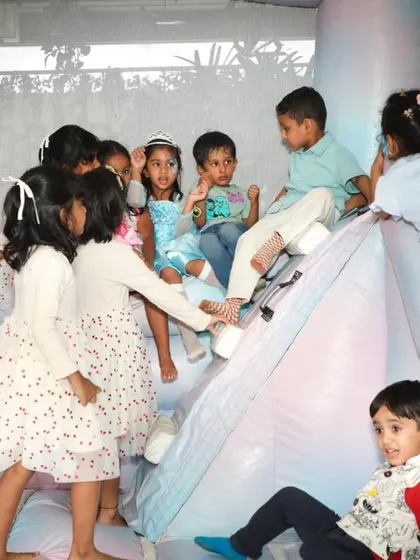 A group of children having a fantastic time on the bouncy castle, a perfect energy outlet that still fit the party's sophisticated winter theme.
