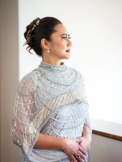 An elegant portrait by the window. This shot from a silver anniversary celebration has a classic, graceful feel.